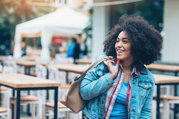 Beautiful smiling girl outdoors in the city