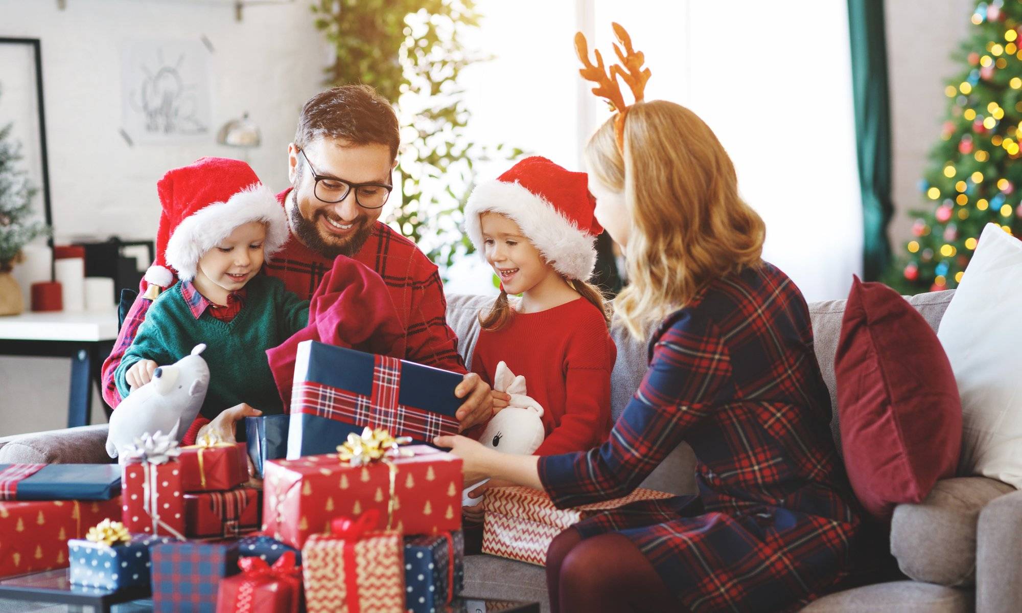 happy family open presents on Christmas morning happy family parents and children open presents on Christmas morning